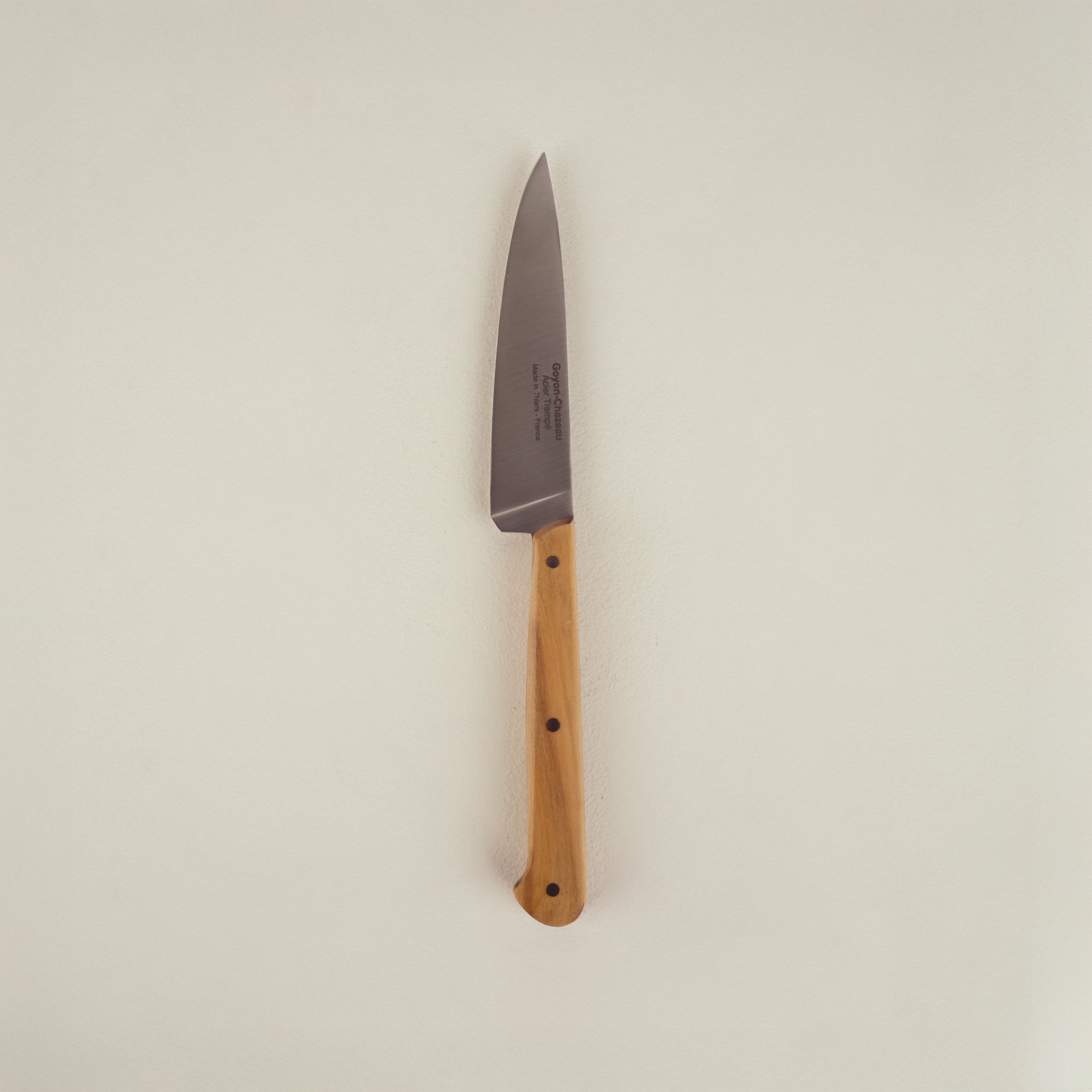 Small knife with a wooden handle on a beige background