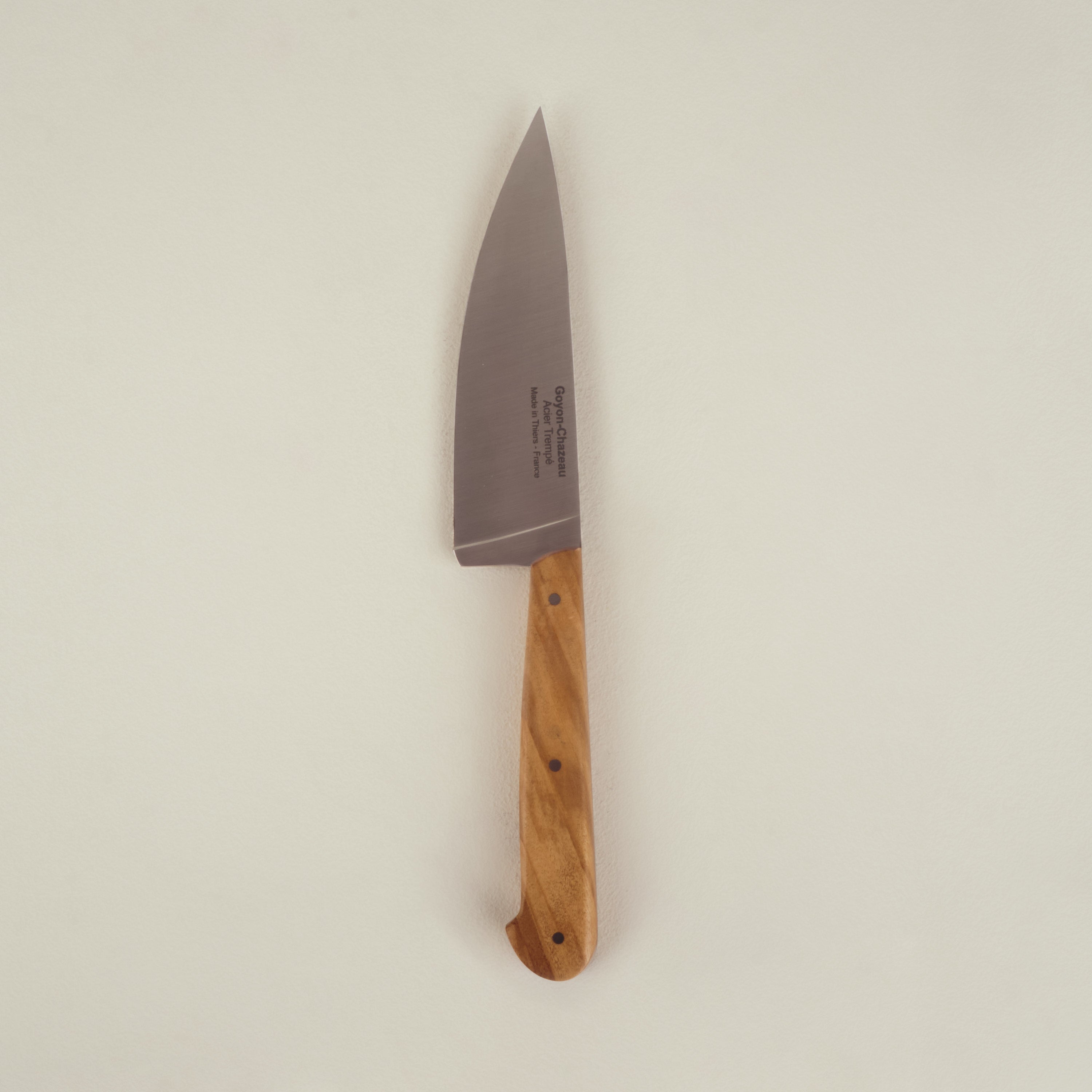 Large knife with a wooden handle on a beige background