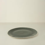 Green ceramic plate on a beige background