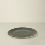 Green ceramic plate on a beige background