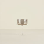 Silver coupe glass on a beige background