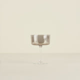 Silver coupe glass on a beige background