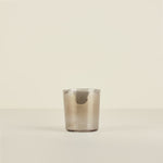 Clear glass tumbler on a beige background