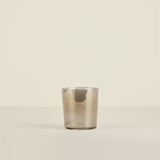 Clear glass tumbler on a beige background