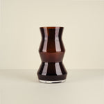 Black glass vase on a beige background