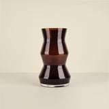 Black glass vase on a beige background