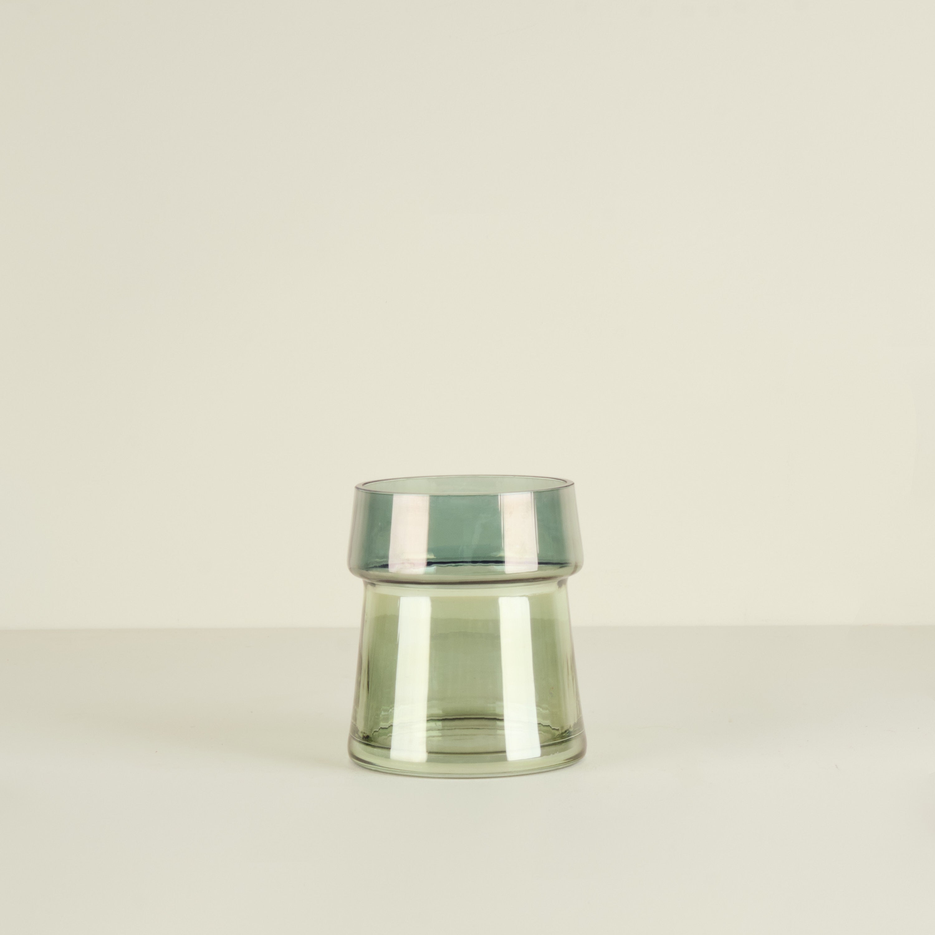 Clear glass vase on a beige background