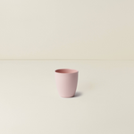 Pink cup on a beige background