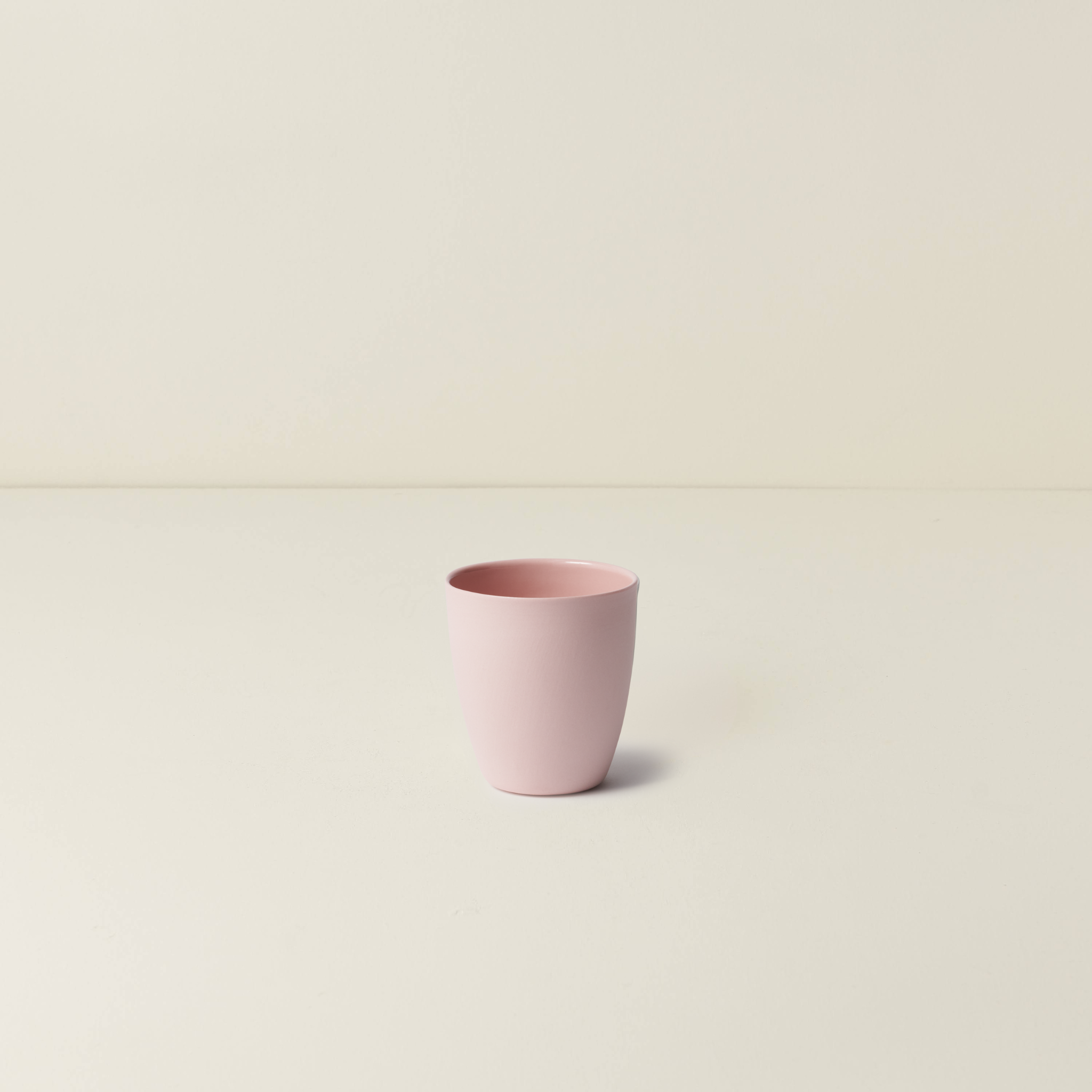 Pink cup on a beige background