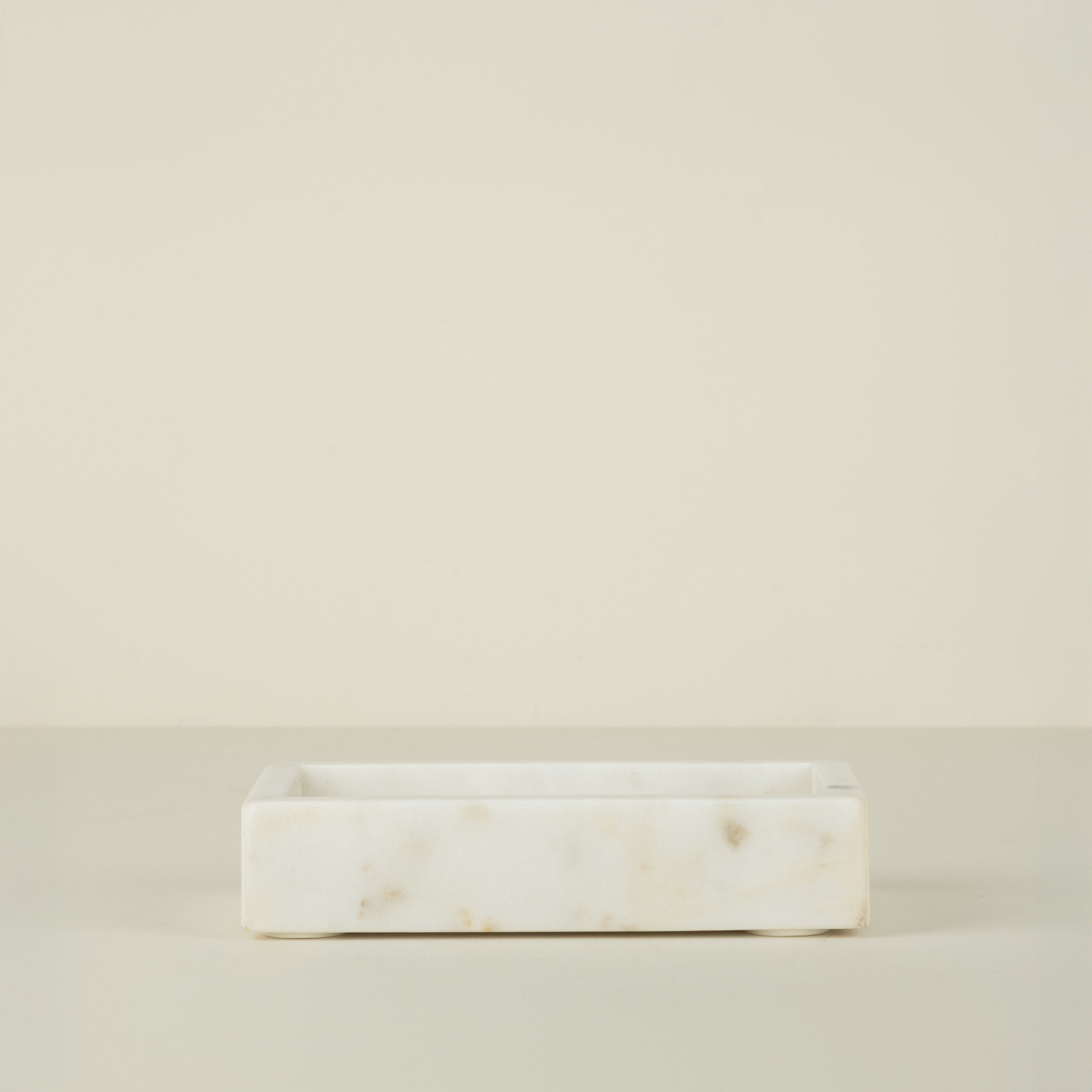 Rectangular marble tray on a beige background
