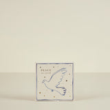Card with a dove illustration and 'Peace on Earth' text on a beige background