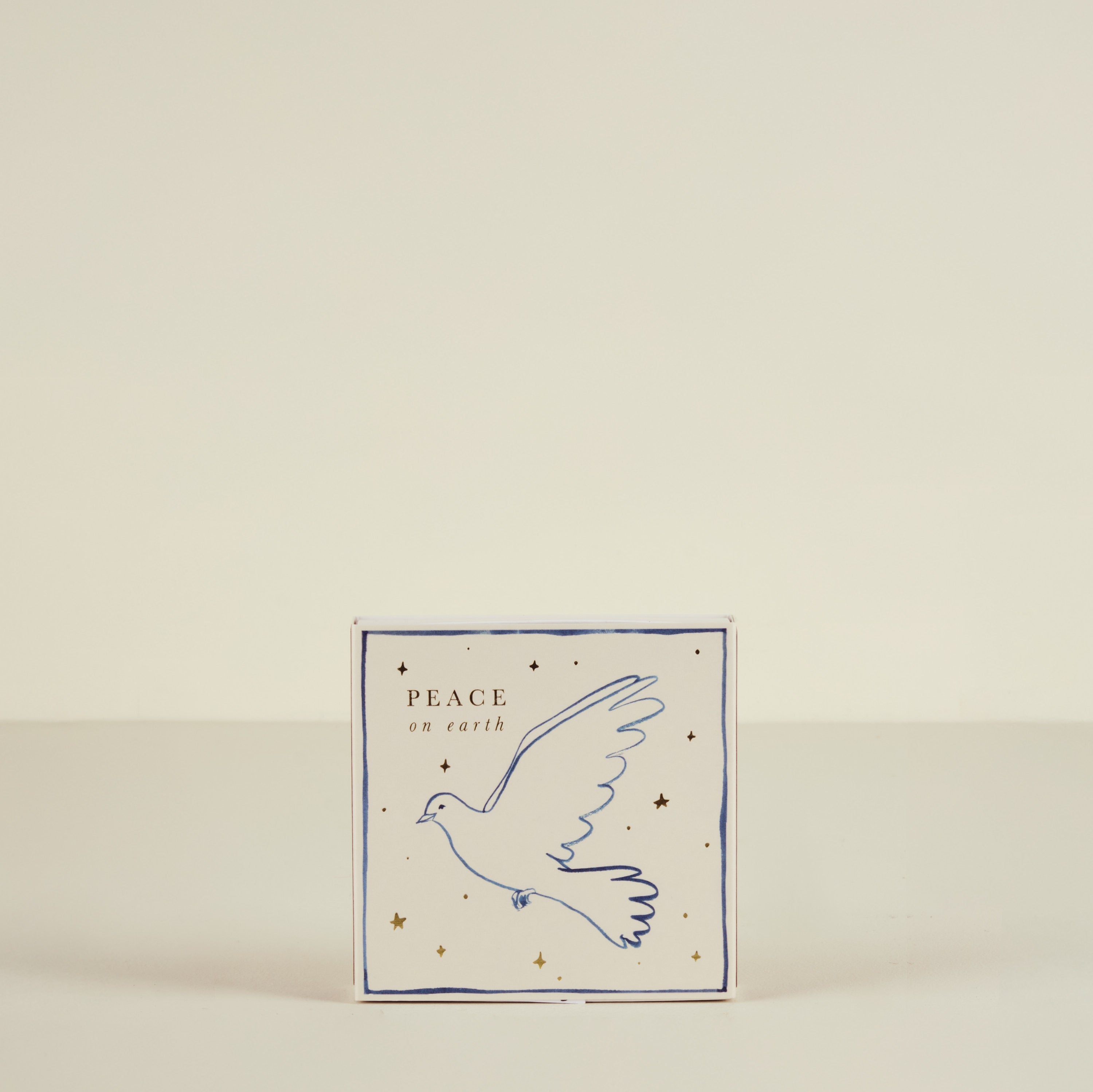 Card with a dove illustration and 'Peace on Earth' text on a beige background