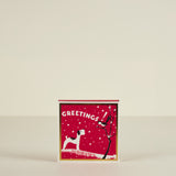 Red greeting card with a dog and tree design on a beige background