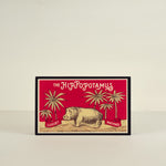 Vintage-style matchbox with hippopotamus design on a beige background