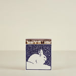 Matches in a box with a rabbit design on a beige background