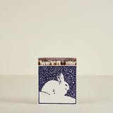 Matches in a box with a rabbit design on a beige background