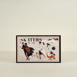 Framed artwork titled 'The Skaters' on a beige background