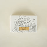 Soap box with a house illustration on the cover against a beige background