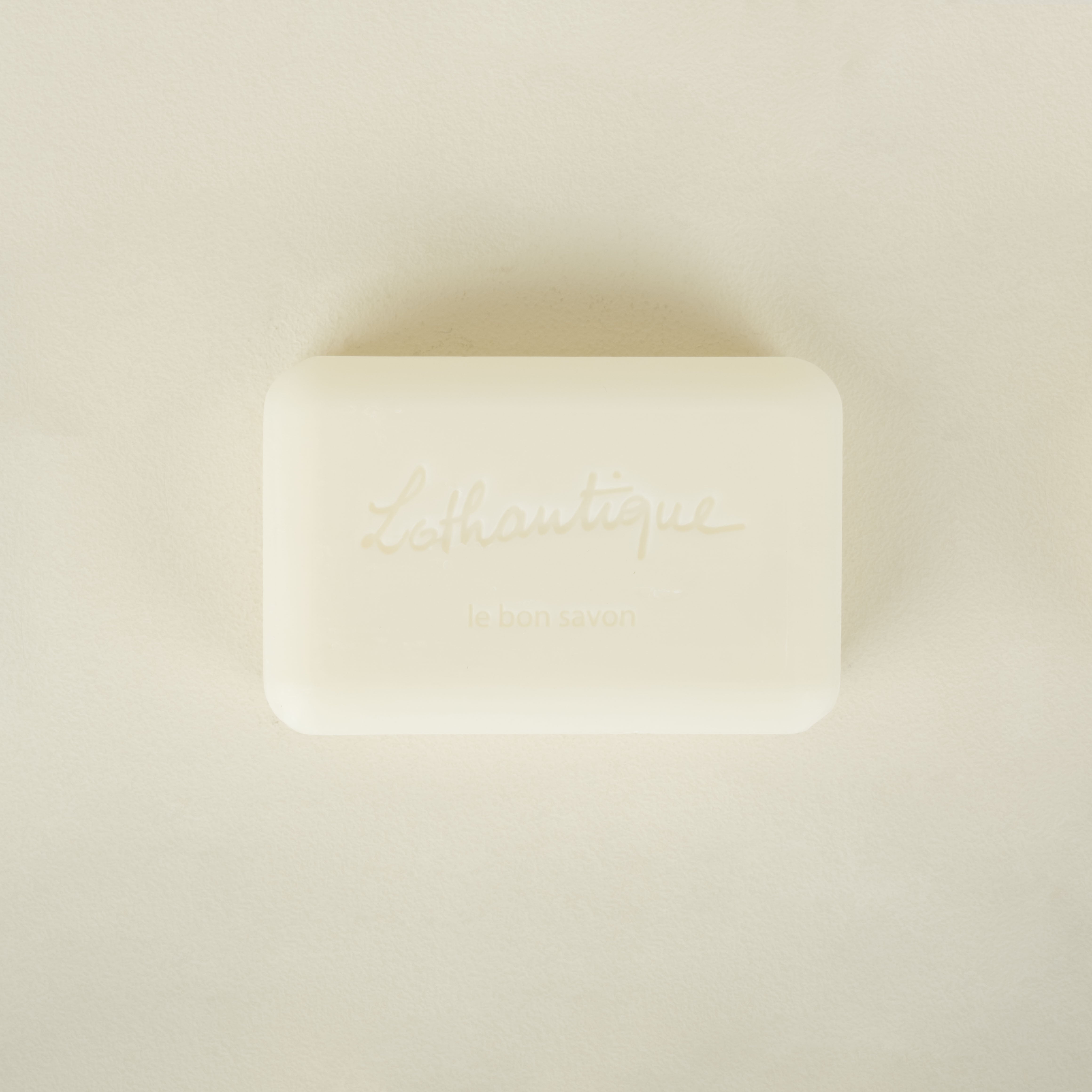 Bar of soap with 'Lothantique' branding on a beige background
