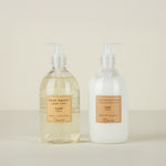 Two bottles of liquid soap and lotion with labels on a beige background