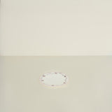 Round decorative plate on a beige background