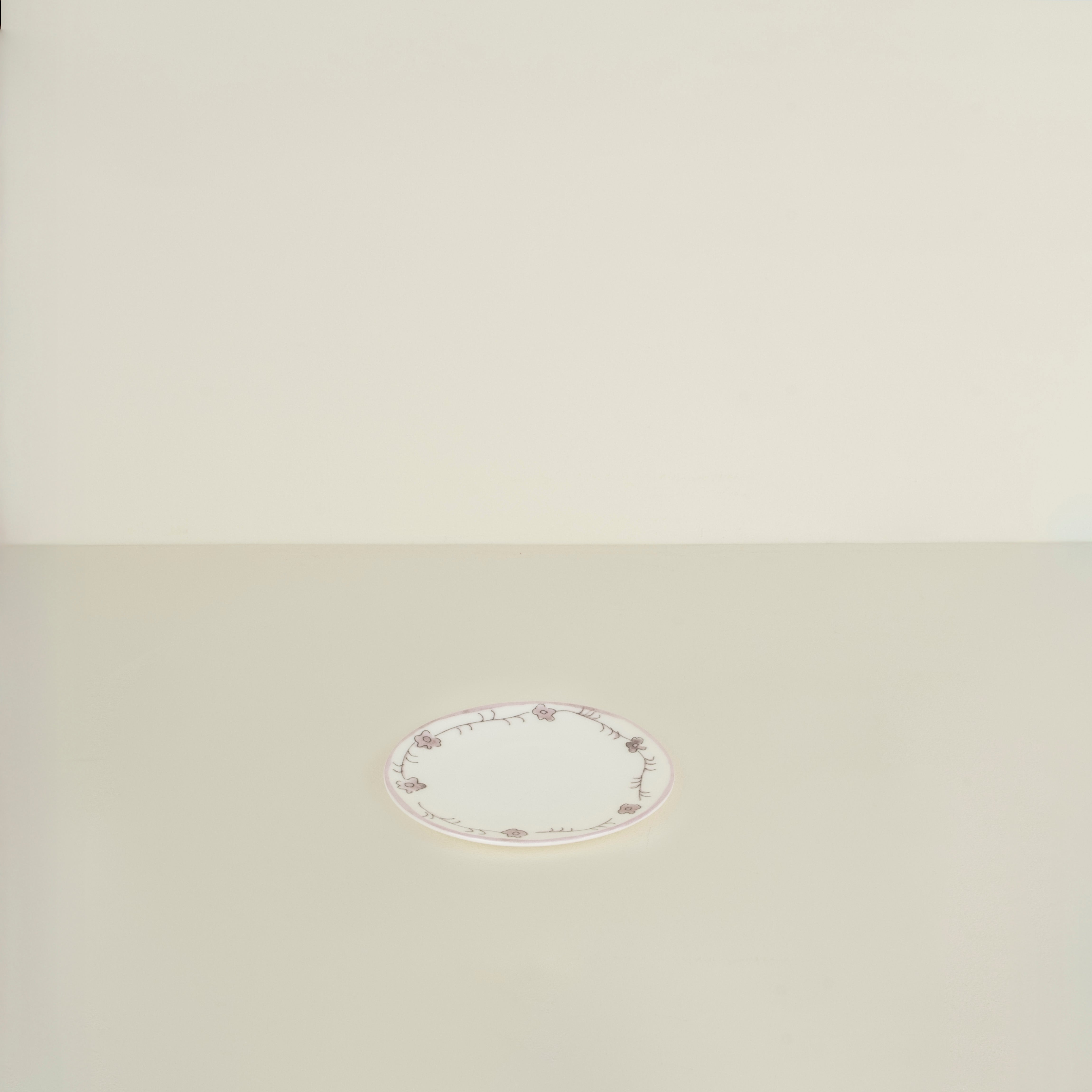 Round decorative plate on a beige background