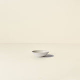 White ceramic bowl on a beige background