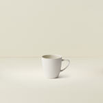 White ceramic mug on a beige background