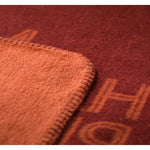 Close-up of a textured red fabric with visible stitching