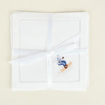 White handkerchief with embroidered design on a beige background