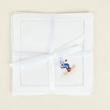 White handkerchief with embroidered design on a beige background