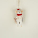 Mouse ornament with a red scarf and Santa hat hanging on a neutral background
