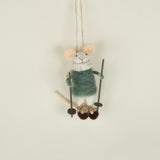 Small plush mouse toy on a swing against a plain background