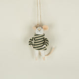 Small plush toy mouse in a striped sweater hanging on a string against a beige background