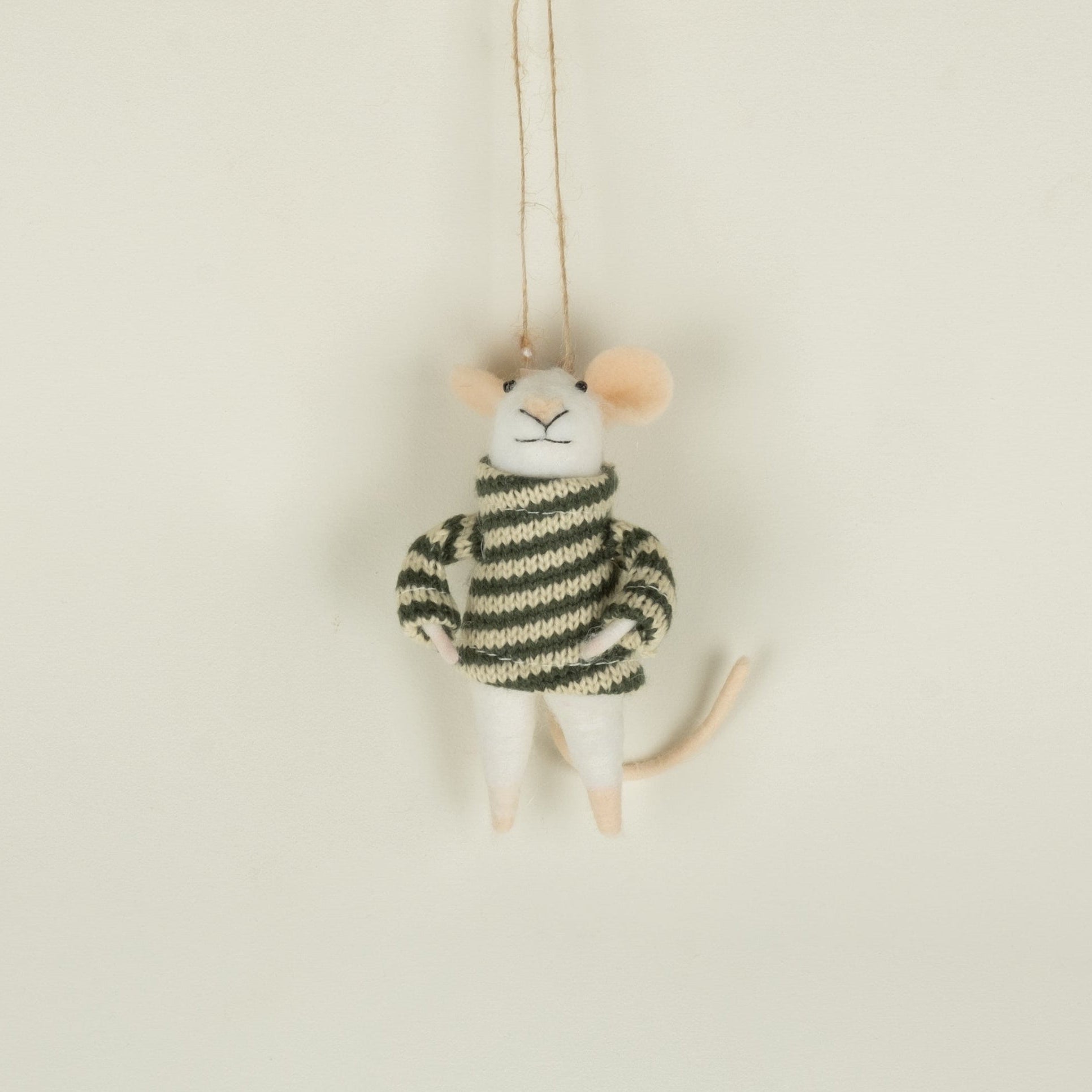 Small plush toy mouse in a striped sweater hanging on a string against a beige background