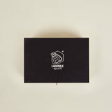 Black Laguiole knife set box on a beige background