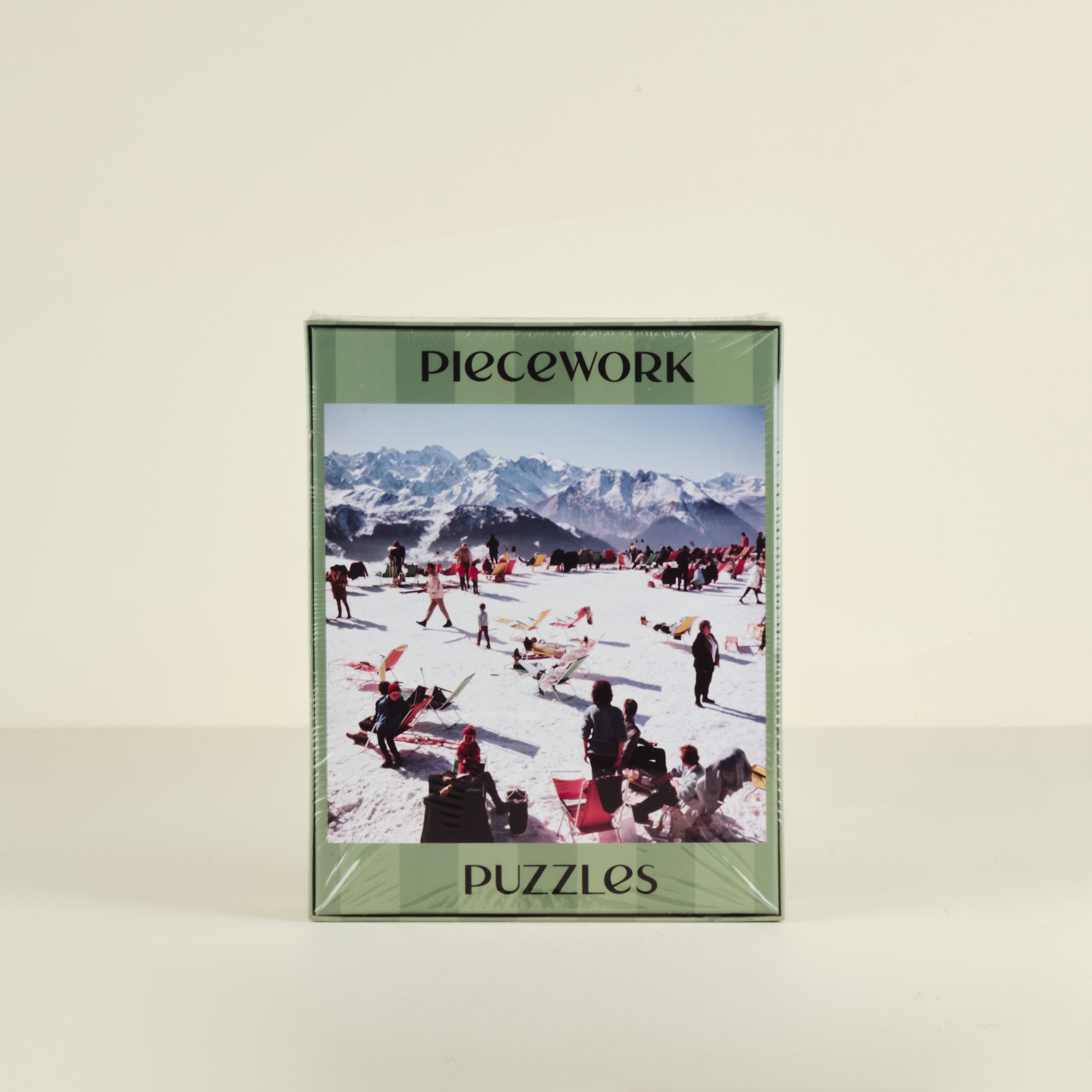 Piecework puzzles packaging with a mountain scene on a beige background