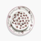 Decorative ceramic plate with floral pattern on a white background