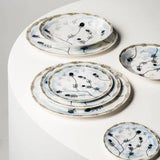 Set of ceramic plates with floral patterns on a white surface