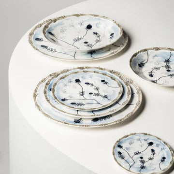 Set of ceramic plates with floral patterns on a white surface