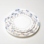 Set of three decorative ceramic plates with floral patterns on a white background