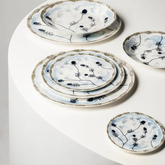 Set of ceramic plates with floral patterns on a white surface