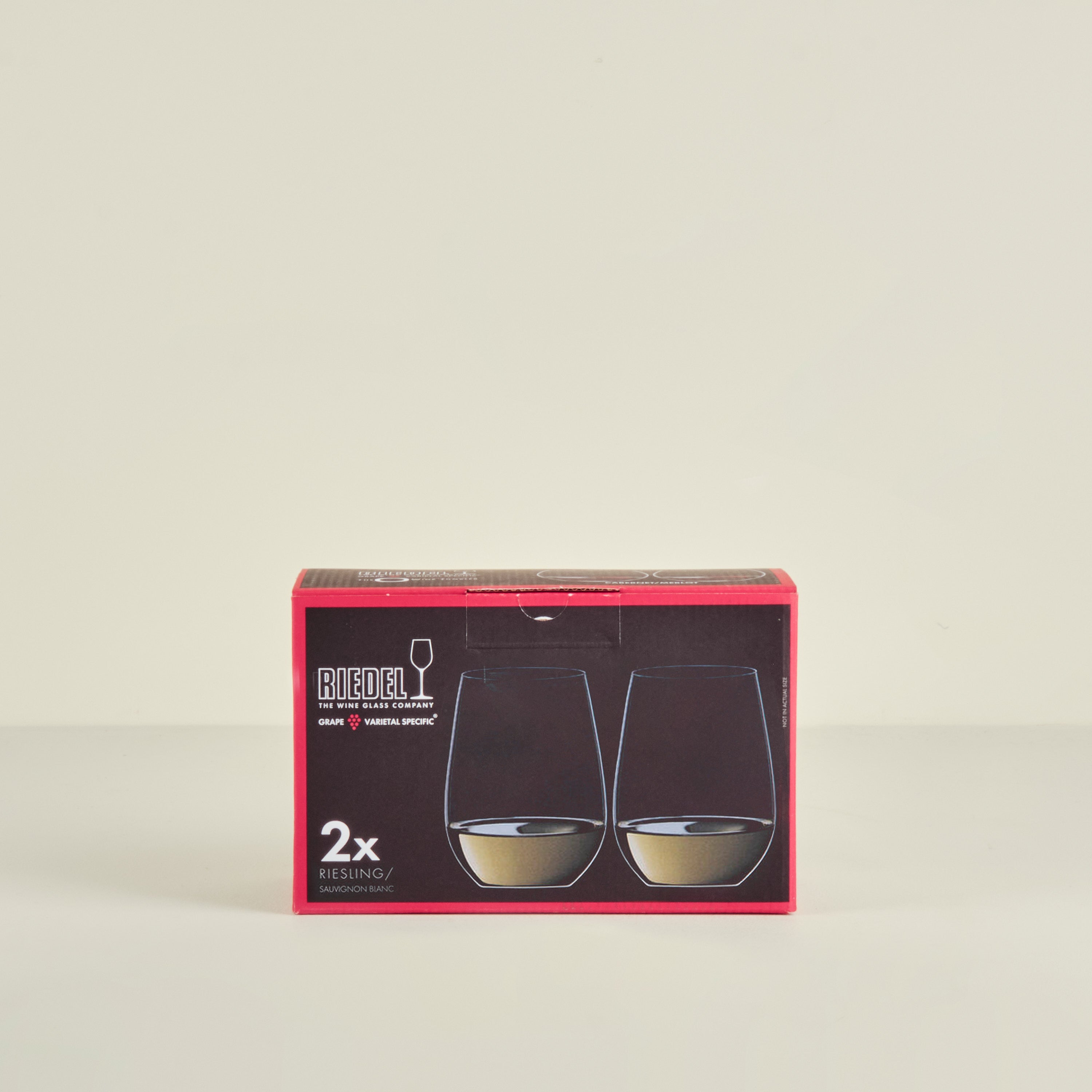 Box of Riedel wine glasses on a beige background