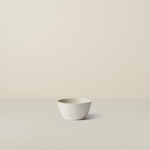 White ceramic bowl on a beige background