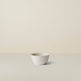 White ceramic bowl on a beige background
