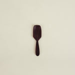 Wooden spatula on a beige background