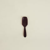Wooden spatula on a beige background