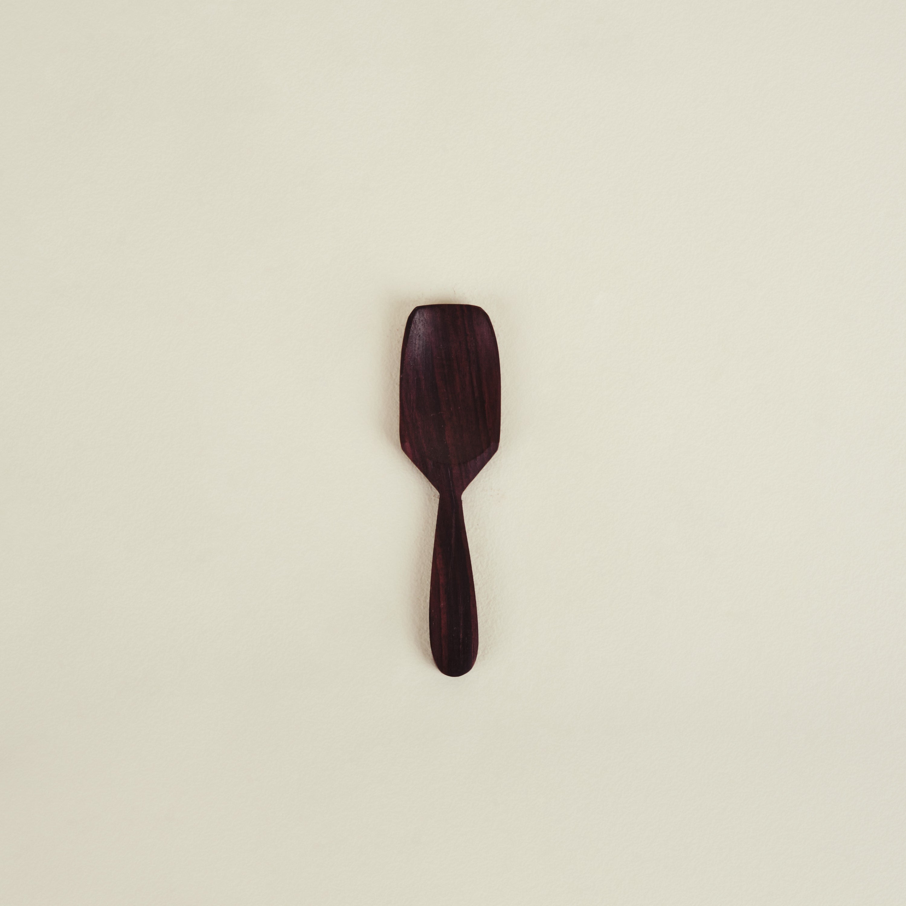 Wooden spatula on a beige background