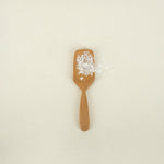 teak salt spoon holding salt