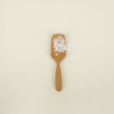 teak salt spoon holding salt